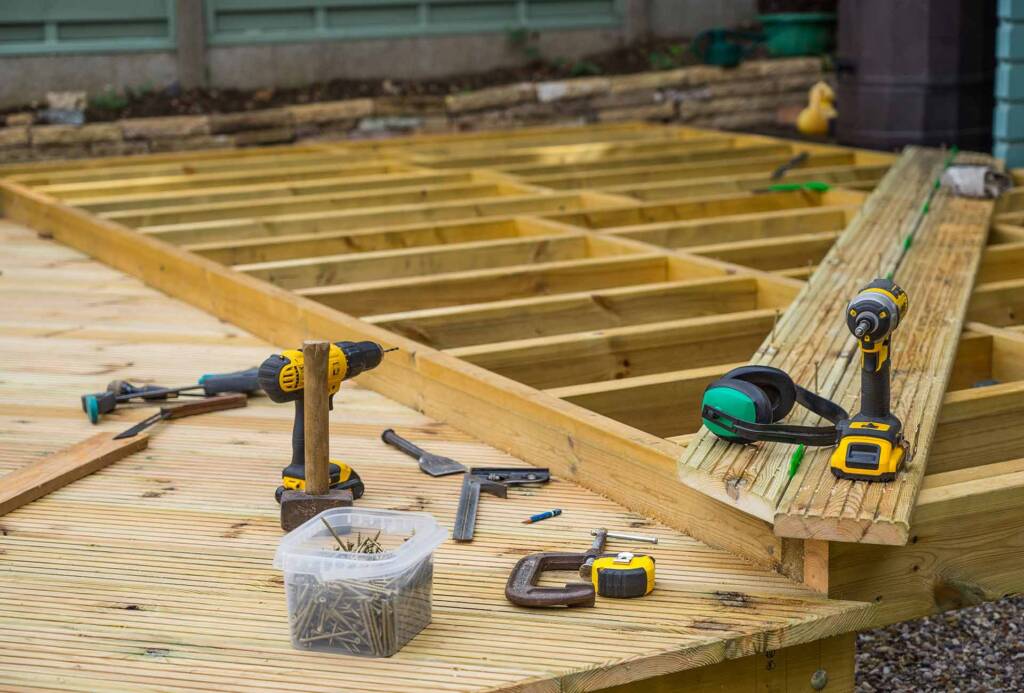 Tools are on a wooden deck being constructed in New Jersey by United Land and Snow Maintenance