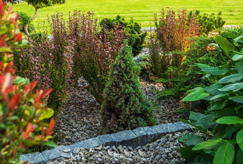 A New Jersey planter with mulch and stone by United Land and Snow Maintenance Company